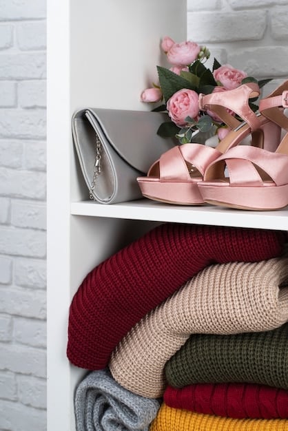 A capsule wardrobe neatly organized on clothing racks. The wardrobe includes essential items such as a classic white shirt, a black blazer, tailored trousers, a denim jacket, and neutral-colored sweaters. The overall aesthetic is minimalistic and chic, showcasing how versatile pieces can create multiple outfits.