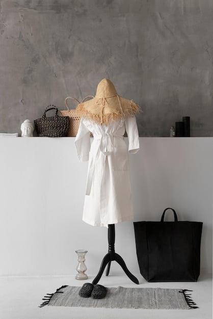 A rack of clothing in a minimalist style, featuring garments in a neutral color palette such as beige, white, grey, and black. The clothes are neatly spaced and well-organized.