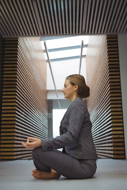 A business professional meditating in a quiet office space, with soft light filtering through the window. She is sitting cross-legged on a yoga mat, her eyes closed, and her hands resting gently on her knees. The office is uncluttered and serene, with a plant in the corner adding a touch of nature. Her posture is straight, reflecting a sense of calm and focus.
