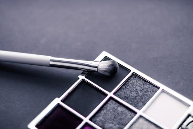 A detailed closeup showcasing a set of professional makeup brushes, including blending, shader, and liner brushes, neatly arranged with various eyeshadow palettes in neutral and smoky shades.