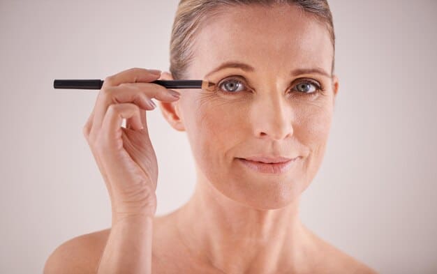 A close-up of a mature woman's eye with beautifully applied eyeshadow in soft, neutral tones. Her eyebrows are well-defined, and the eyeliner is subtly smudged for a softer look.