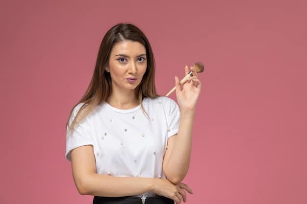 A makeup artist demonstrating the correct way to hold a blending brush on a model's eye, showing the soft, circular motions needed for a seamless gradient. The brush is fluffy and the shadow is evenly distributed.