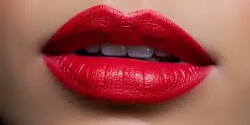 Woman with perfectly applied vibrant red long-lasting lipstick
